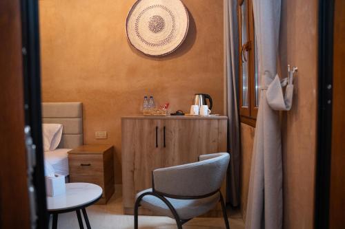 a small room with a chair and a small cabinet at بيت المقصرة Almuqasrah house in Nizwa