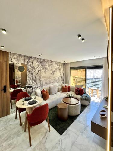 a living room with a white couch and tables at Arena Maarif 41 in Maarif