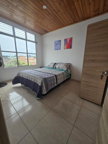 a bedroom with a bed and a wooden ceiling at Luxury flandes in Flandes