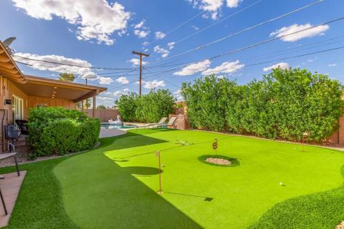 a yard with a green lawn with a putting green at Games Galore - Old Town Scottsdale - Pool & Golf in Scottsdale
