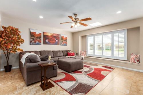 a living room with a couch and a ceiling fan at Games Galore - Old Town Scottsdale - Pool & Golf in Scottsdale