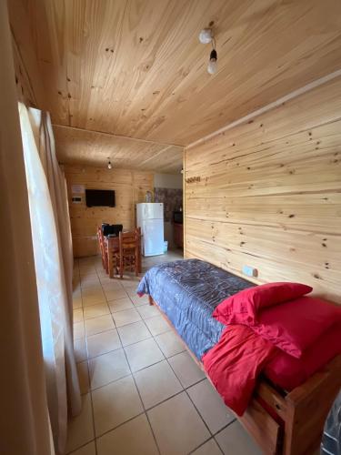 a bedroom with a bed in a wooden room at Vista del Plata - Alojamiento in Potrerillos