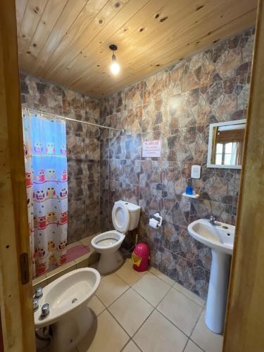 a bathroom with two toilets and a sink and a shower at Vista del Plata - Alojamiento in Potrerillos