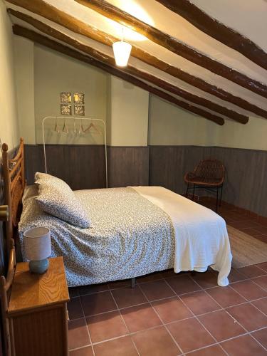 a bedroom with a bed and a table and a chair at Casa Castillo in Moratalla