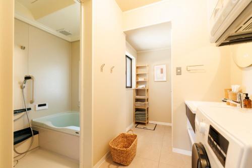 a bathroom with a sink and a bath tub at kobito in Toyama