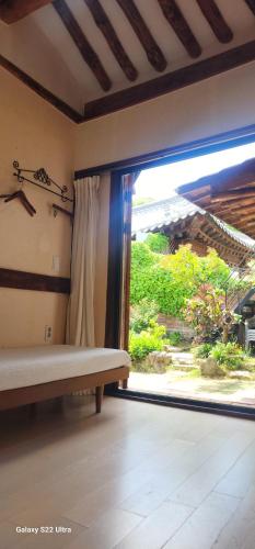 a room with a window with a bench in front of it at Eosahwa Hanok Stay Featured in Petit Futé 2026 in Jeonju