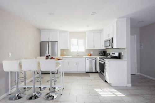 a white kitchen with white cabinets and white appliances at Casa Con Casita - Private Pool - 8 min to Old Town in Scottsdale