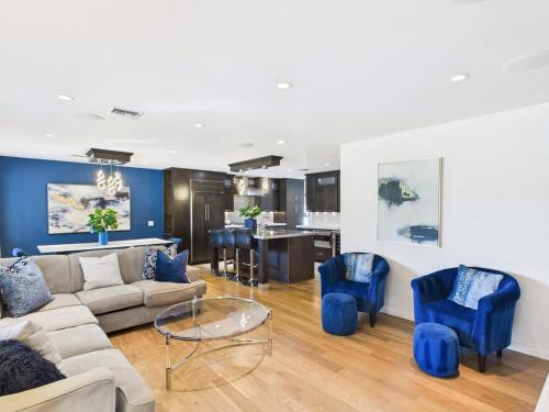 a living room with a couch and blue chairs at Azure - Sparkling Pool - Pool Table - In Old Town in Scottsdale
