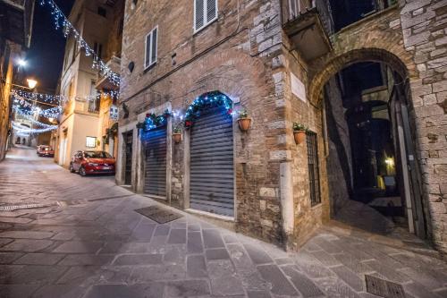 an alley in an old town at night with christmas lights at Vermaaten Boutique Suites Emerald in Todi