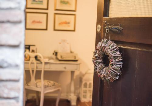 a door with a wreath on it in a room at Vermaaten Boutique Suites Emerald in Todi