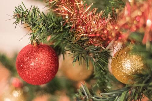 a christmas tree with red and gold ornaments at Vermaaten Boutique Suites Emerald in Todi