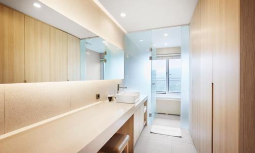 a bathroom with a sink and a mirror at Belle Fore Resort in Jeungpyeong