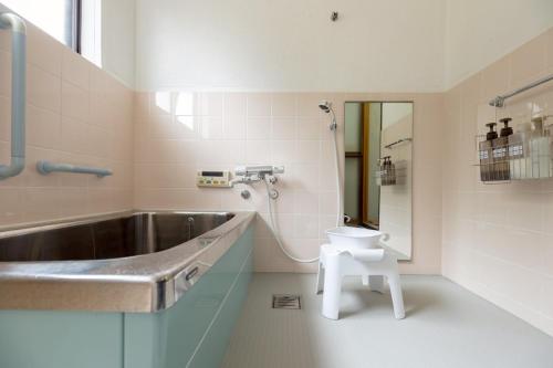 a bathroom with a sink and a toilet in it at Nagi no Ne in Washika