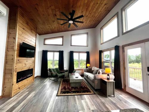 a living room with a couch and a fireplace at Spruce Arch - King Bed Fireplace Pets Welcome in Rogers