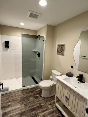 a bathroom with a shower and a toilet and a sink at Mill View Suite - River Rock Inn in Bellevue