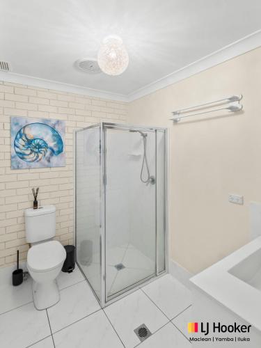 a bathroom with a shower and a toilet at Barefoot by the Bay in Iluka