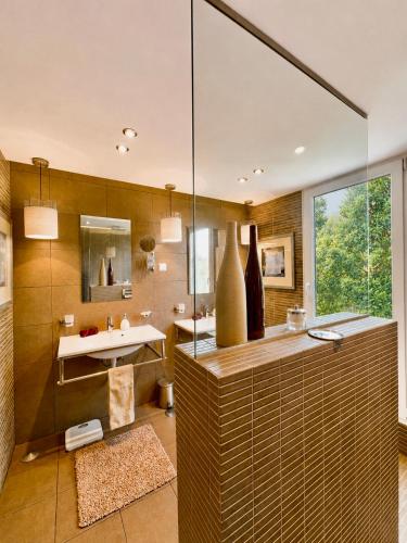 a bathroom with a sink and a mirror at CASA DO LAGO, Infinity Pool, Mountains & Sea view in Estói