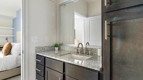 a bathroom with a sink and a mirror at Landing Apartments - Reserve at City Place in Conroe