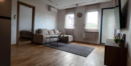 a living room with a couch and a table at Apartment N22 in Leštane