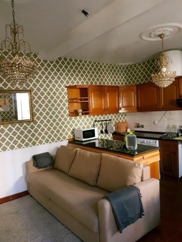 a living room with a couch in a kitchen at Cozy Sintra Townhouse in Sintra