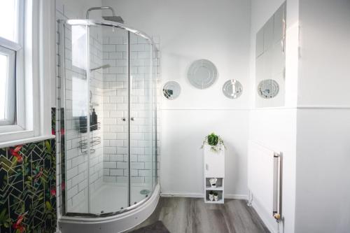 a white bathroom with a glass shower at 8ight Havens - Channel Euro Tunnel - Folkestone in Folkestone