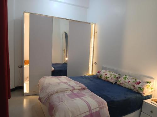 a bedroom with a large mirror and a bed at Sunny said gust house in Al Aqālitah