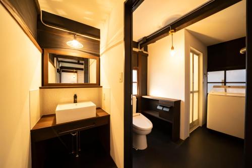 a bathroom with a sink and a toilet at 青木邸 in Tokushima