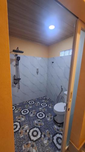 a bathroom with a toilet and a sink at SleepHere Homestay in Bayan