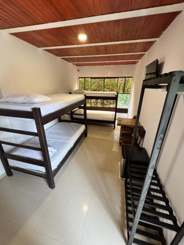 a room with two bunk beds and a staircase at SERRANTE Hotel Campestre in Villavicencio