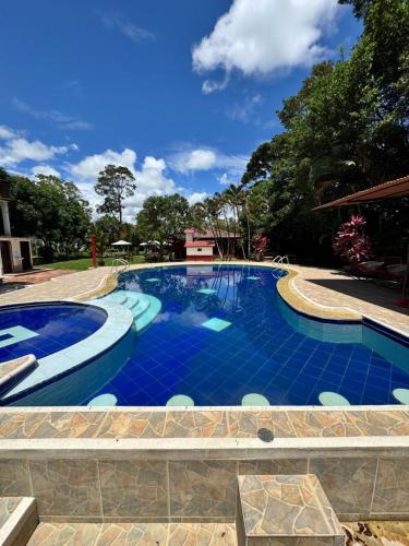 a large swimming pool with blue tiles on it at SERRANTE Hotel Campestre in Villavicencio