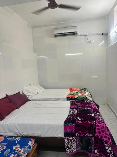 a bedroom with a bed with a blanket on it at La Maison D&N in Pondicherry