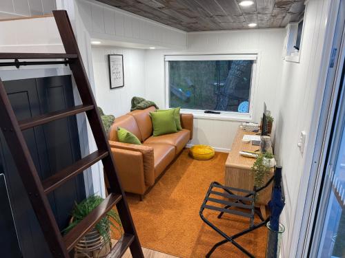 a living room with a couch and a table at Big Tiny Medlow in Medlow Bath