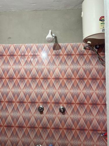 a close up of a bathroom with a checkered at La Maison D&N in Pondicherry