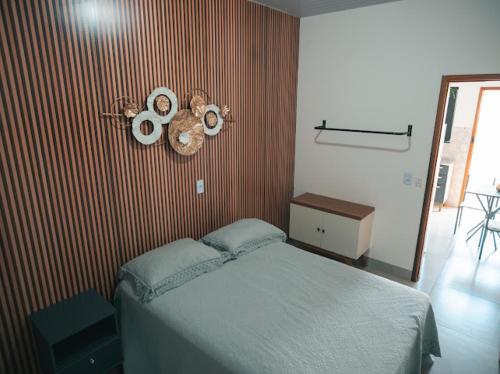 a bedroom with a bed and a red striped wall at Residencial Antônio Floriza in Sinop