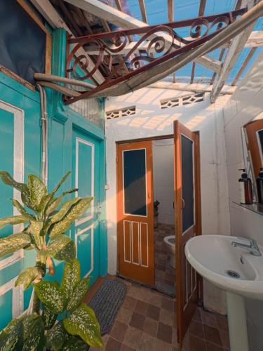 a bathroom with a plant and a sink at Laura's Backpacker 523 in Yogyakarta