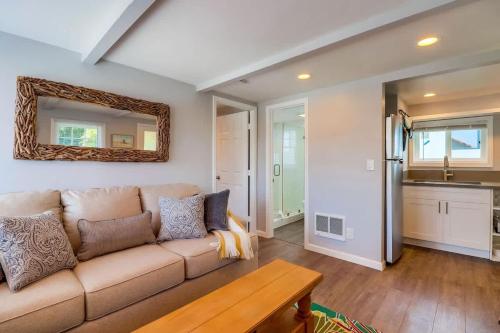 a living room with a couch and a mirror at Bette's Bungalow in San Diego