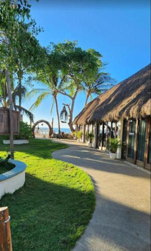 a path leading to a resort with trees and a beach at Villas Manchineel in Sayulita