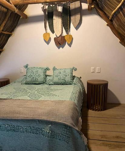 a bedroom with a bed with two pillows at Villas Manchineel in Sayulita