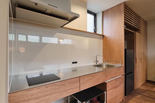 a kitchen with a sink and a counter at Hotel GGG Asahikawa in Asahikawa