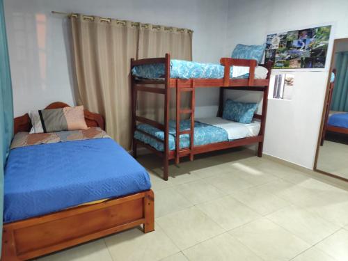 a bedroom with two bunk beds and a bed at Casa Manaba in Baños