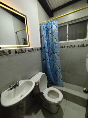 a bathroom with a toilet and a sink at Casa Manaba in Baños