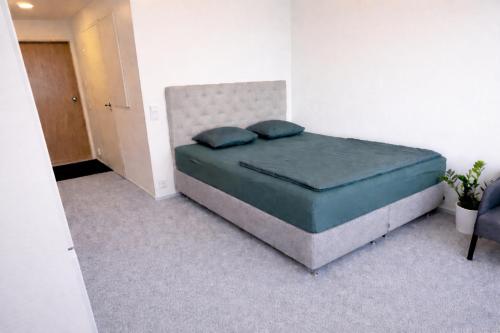 a bedroom with a bed with two pillows on it at Nord Heaven in Turku