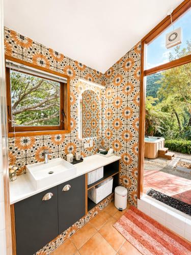 a bathroom with a sink and a window at Eirene Retreat - Quiet Riverside Escape in Upper Hutt