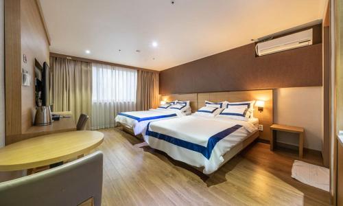a hotel room with two beds and a table at Incheon Wolmido Stellamaris Hotel in Incheon