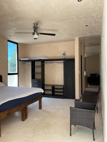 a bedroom with a bed and two chairs in it at Villa Colibries Chelem in Chelem