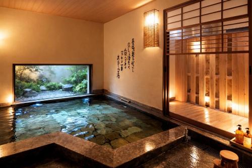 an aquarium in a room with a fish tank at Good Stay Mizuho in Usa