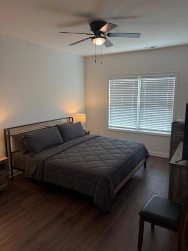 a bedroom with a bed and a ceiling fan at Brand new condo right off the interstate in Berea