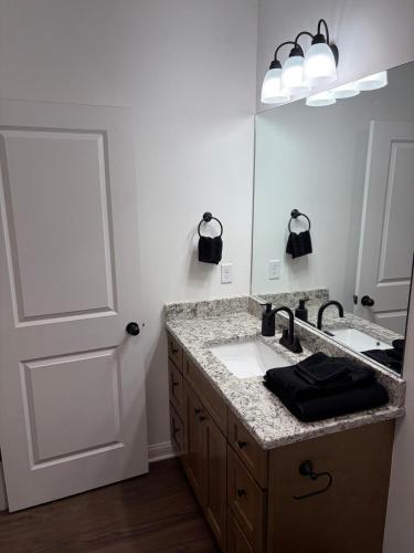 a bathroom with a sink and a mirror at Brand new condo right off the interstate in Berea