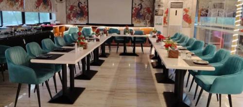 a row of tables and chairs in a restaurant at Le-Leisure Hotel in Prayagraj