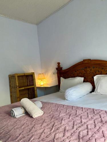 a bedroom with two beds with towels on them at Sulis homestay in Kuta Lombok